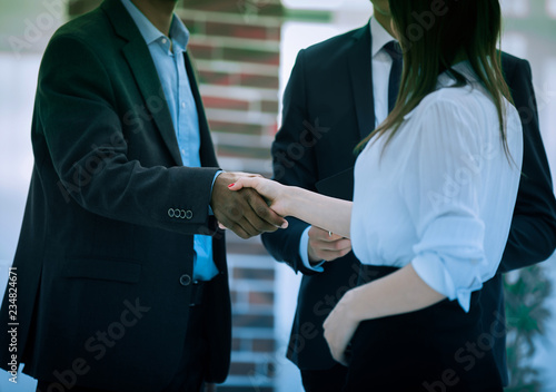 closeup .business handshake financial partners on the background of the office