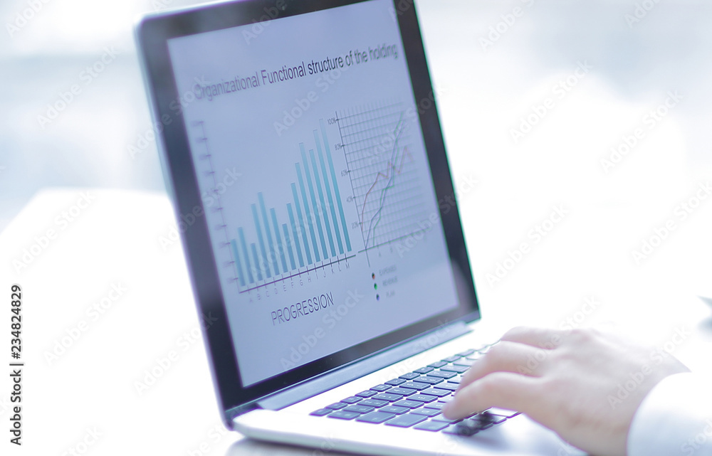businessman working on laptop with financial data. businessman working on laptop with financial data.