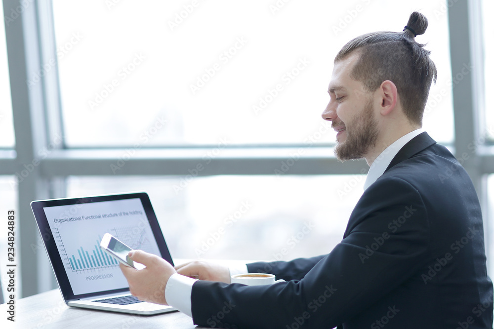 casual businessman working with mobile and laptop in modern office casual businessman working with mobile and laptop in modern office