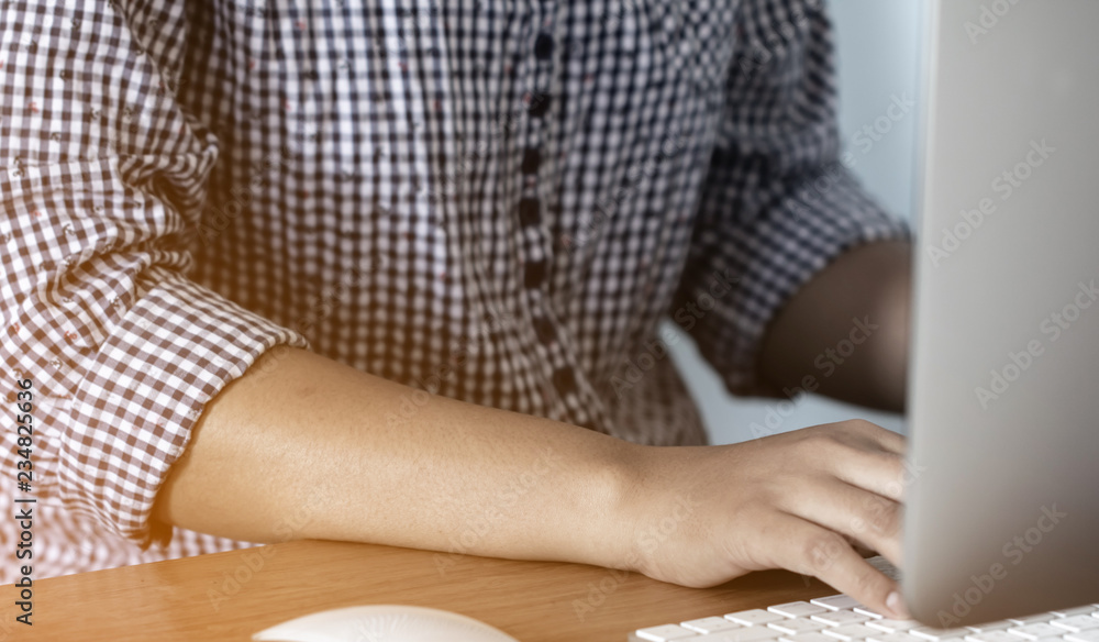 Fototapeta premium Lady working at home with computer,Her hand holding pen writing a blog and Creative idea of work 2019 goals, writing, drawing, making notes in document Business,investment,concept,Soft focus.