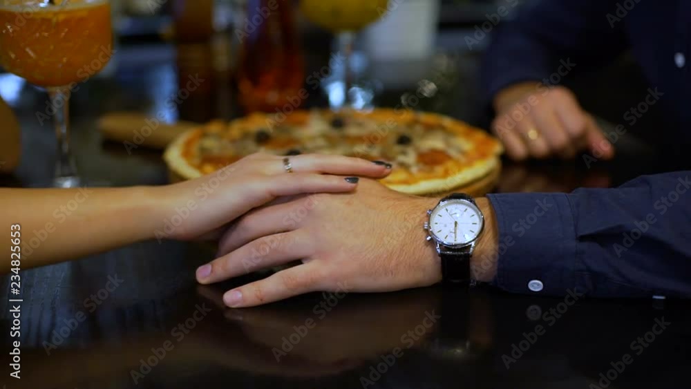 Woman Strokes Man`s Hand in Restaurant Woman Strokes Man`s Hand in Restaurant