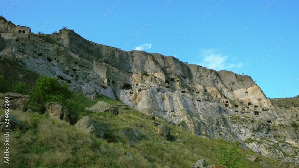 Vardzia - ancient cave town carved in rock, Georgia. Slow motion dolly shot