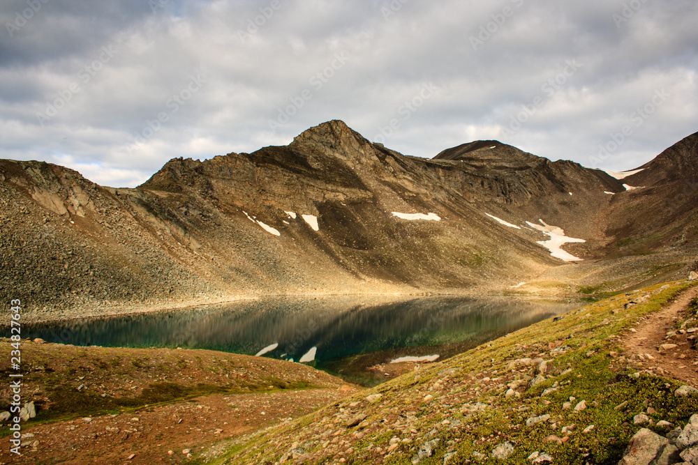 Fototapeta premium Small mountain lake at the feet of the pass