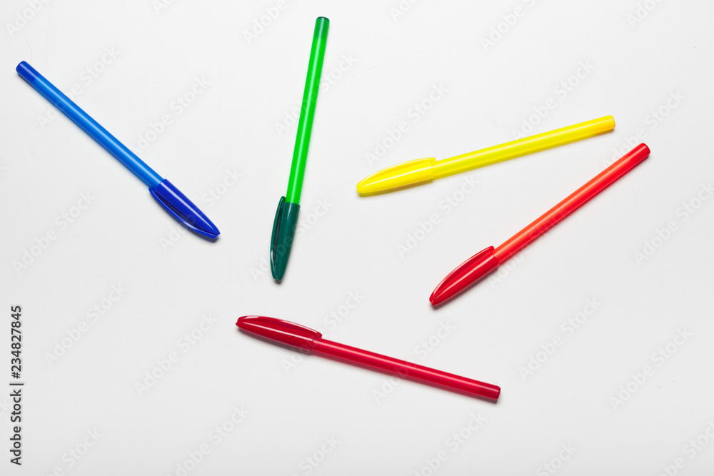 different colors pens isolated on the white background