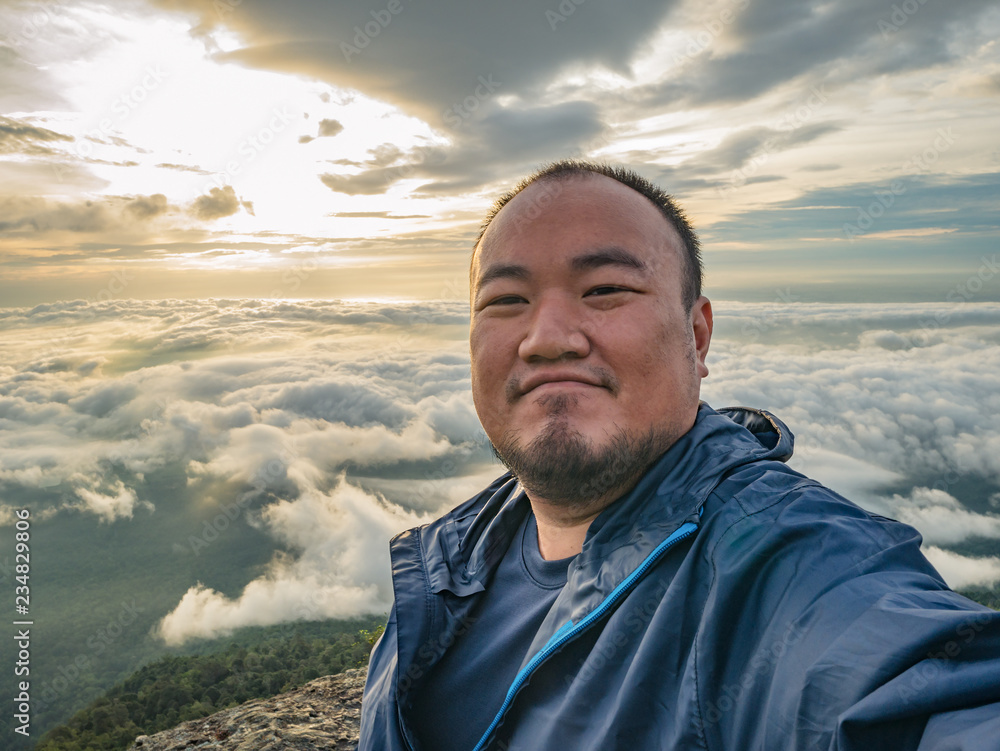 Asian Traveler Take a Selfie with Beautiful Sunrise Sky on the mountain Asian Traveler Take a Selfie with Beautiful Sunrise Sky on the mountain