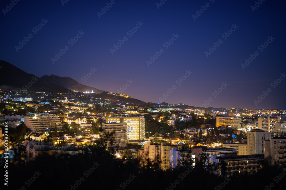 Beautiful Night View On Top Of Hill Overlooking The City Of Malaga, Spain At Night