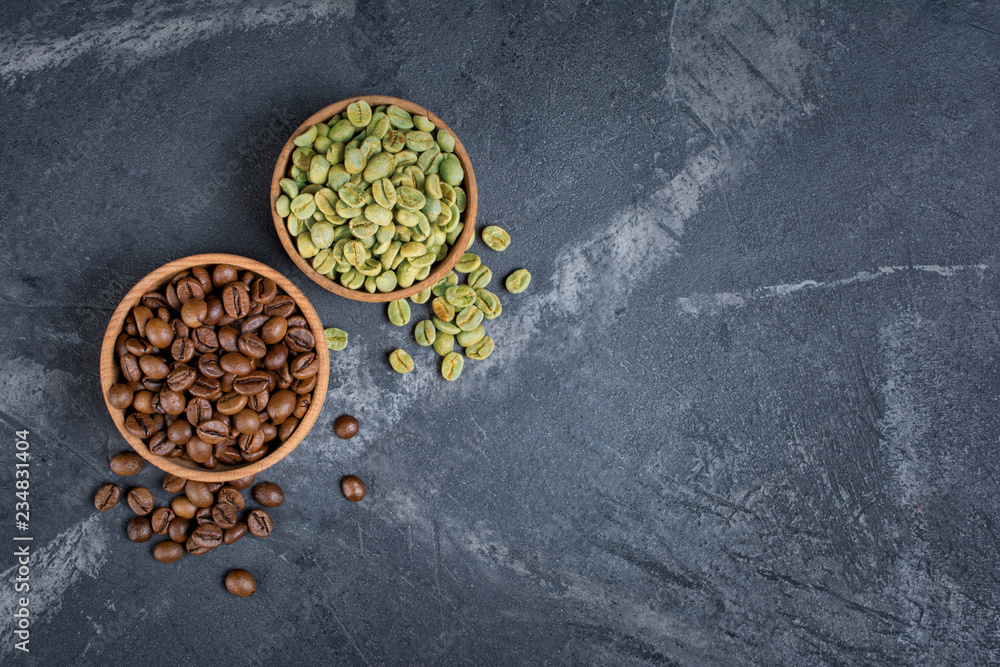 Top view of raw green and brown roasted coffee beans in wooden bowls Top view of raw green and brown roasted coffee beans in wooden bowls