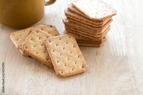 Milk cracker cookies Served with hot coffee on wooden desk ,Time break