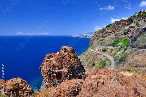 Coastline on Ponta do Garajau, view at rocky beach and Funchal, Madeira island, Portugal