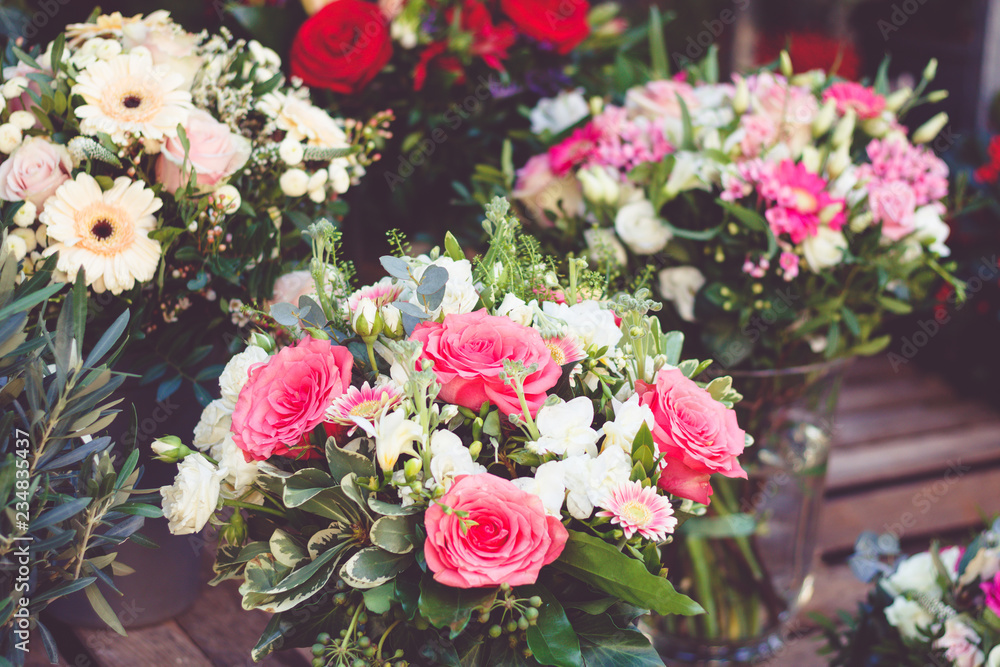 Beautiful bouquet with pink roses on a showcase in a French shop outside. Beautiful bouquet with pink roses on a showcase in a French shop outside.