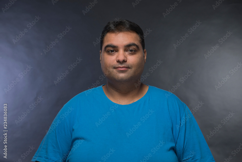 Portrait of smiling fat man against a black background Portrait of smiling fat man against a black background