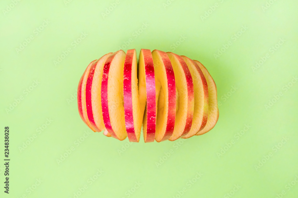 fresh ripe red apple sliced in circles.