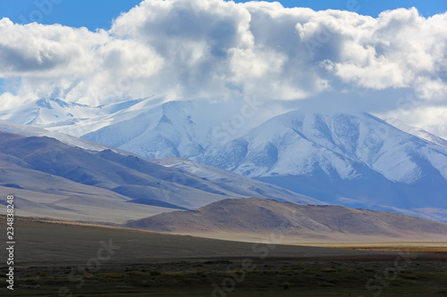 Natural landscape of the beautiful snow mountain with cloudy and large steppe at Western Mongolia