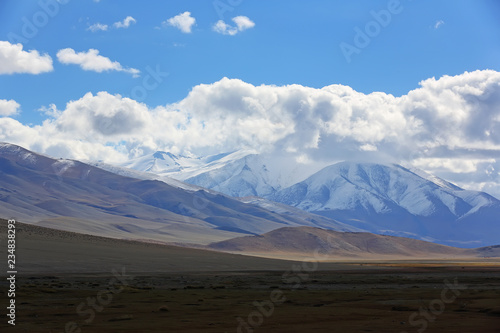Natural landscape of the beautiful snow mountain with cloudy and large steppe at Western Mongolia