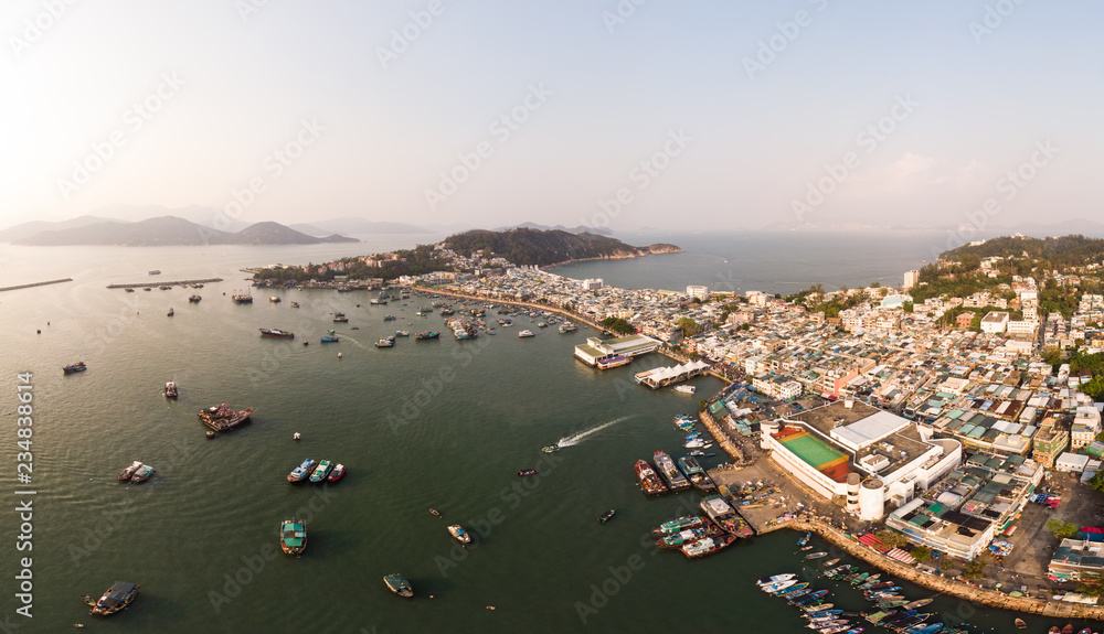 Stunning aerial panorama of the Cheung Chau island in Hong Kong with its famous fisherman harbor. The island is a popular day trip from Hong Kong.