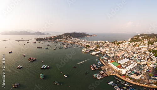 Stunning aerial panorama of the Cheung Chau island in Hong Kong with its famous fisherman harbor. The island is a popular day trip from Hong Kong.