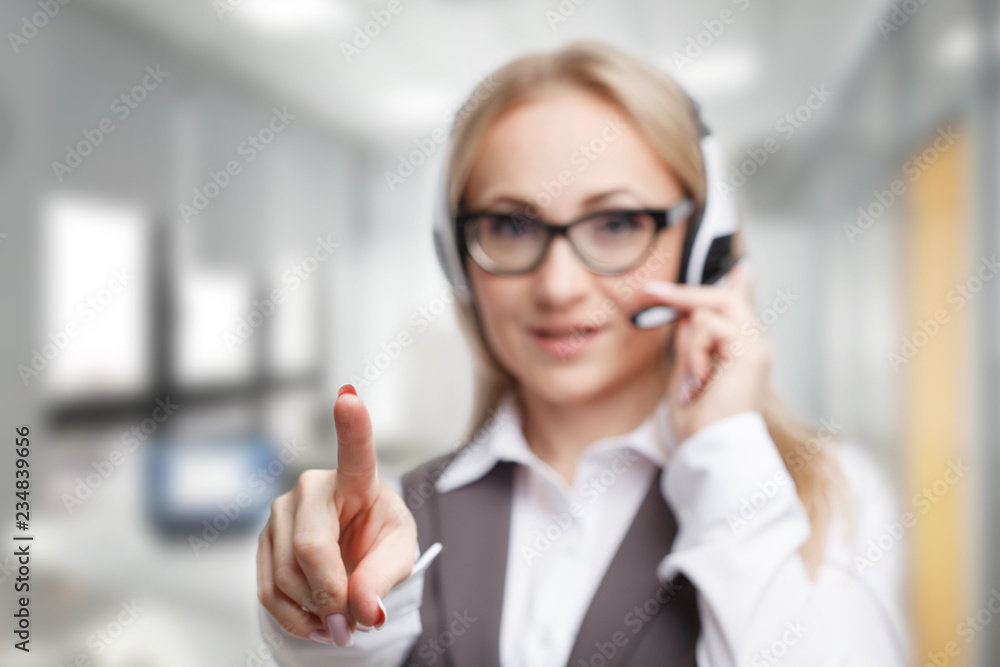 Three call center service operators at work. Portrait of smiling pretty female helpdesk employee with headset at workplace. Three call center service operators at work. Portrait of smiling pretty female helpdesk employee with headset at workplace.