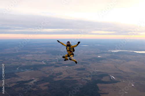 Yellowsuit skydiver is in the sky.