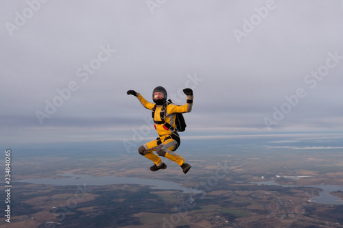 Yellowsuit skydiver is in the sky.