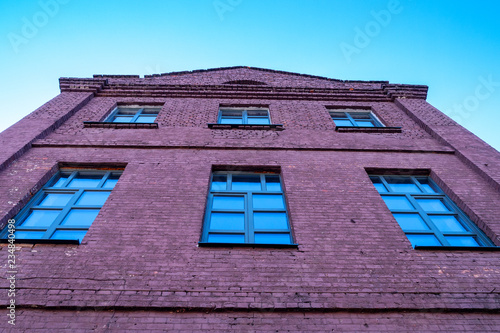 big old brick house, lots of windows looking out into the sky