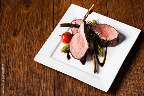 Obraz na płótnie Baked lamb loin, served with asparagus.