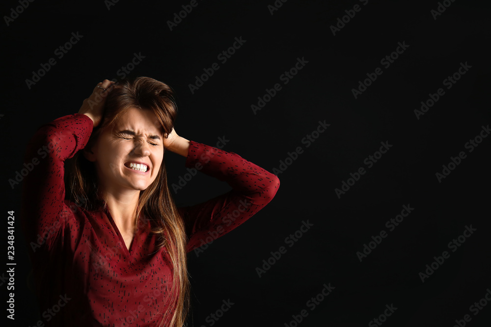 Portrait of stressed young woman on dark background Portrait of stressed young woman on dark background