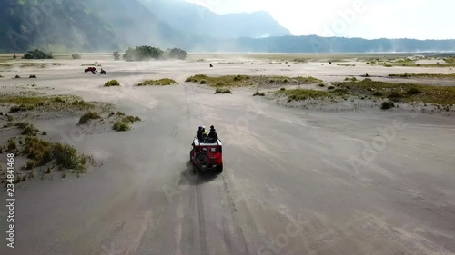 4K Tracking by drone on driving experience to Mt.Bromo, Pasuruan, East Java, Indonesia. Adventure driving Off-road Jeep 4WD into Beautiful active Volcano with smoke Mount Bromo.