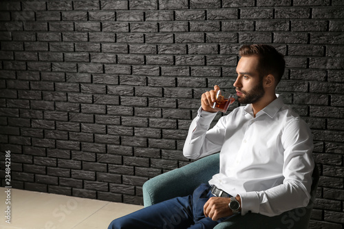 Young businessman drinking ...