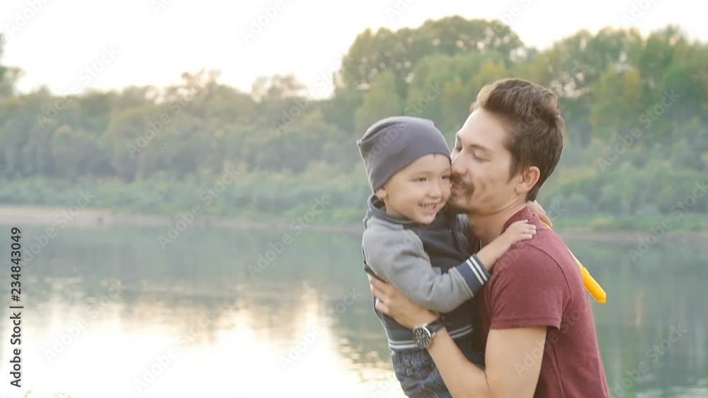 Family and children concept. Happy Father and son having fun in summer park Family and children concept. Happy Father and son having fun in summer park