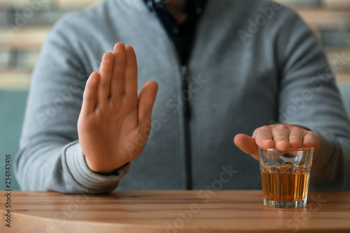 Man refusing to drink whiskey  closeup