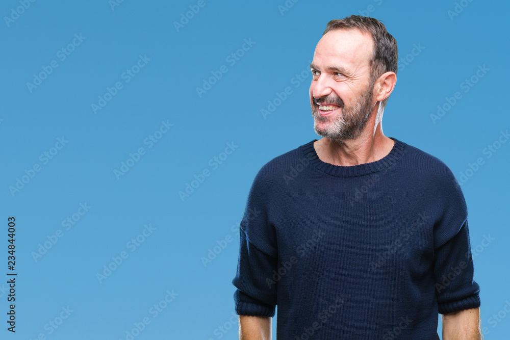 Fototapeta premium Middle age hoary senior man over isolated background looking away to side with smile on face, natural expression. Laughing confident.