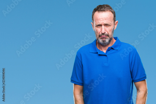Middle age hoary senior man over isolated background depressed and worry for distress, crying angry and afraid. Sad expression.