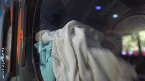 Laundromat Clothes tumble drying in machine close up