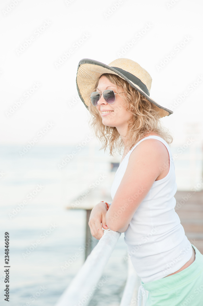 Happy young woman relaxing on pier