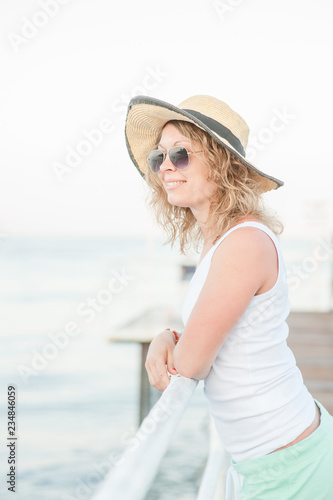 Happy young woman relaxing on pier