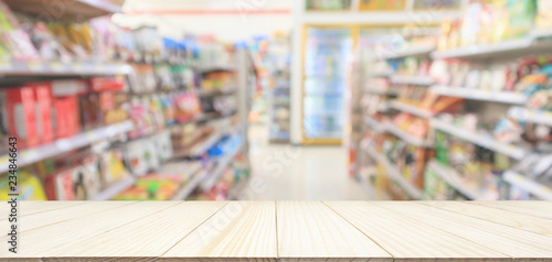 Photography Wood table top with Supermarket convenience store aisle shelves interior blur fo