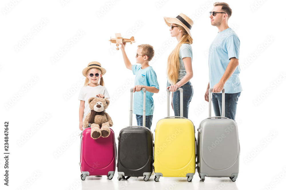 Happy family standing with baggage isolated on white Happy family standing with baggage isolated on white