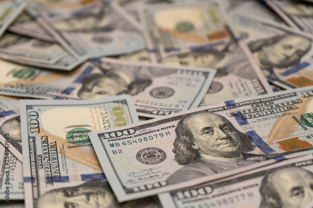 Close-up of scattered hundred dollar bills Close-up of scattered hundred dollar bills