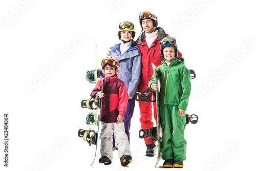 Happy family standing in colourful snowsuits and smiling isolated on white