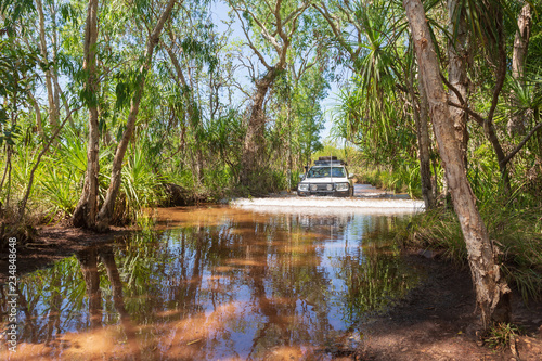 Four wheel drive vehicle fording a creek in the Litchfield National Park, Northern Territory, Australia.