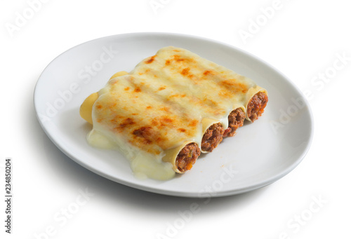 plate of cannelloni with ragù sauce, typical italian food dish photo