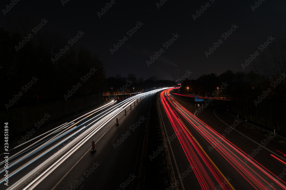 Autobahn bei Nacht mit Leuchtstreifen und Baustelle