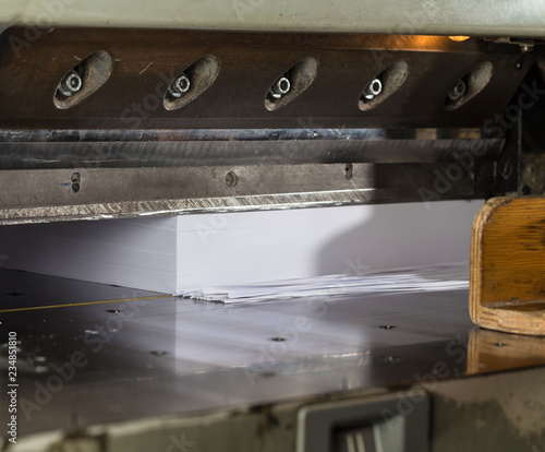 Front view of a paper guillotine in commercial printing industry. Hydraulic industrial guillotine.