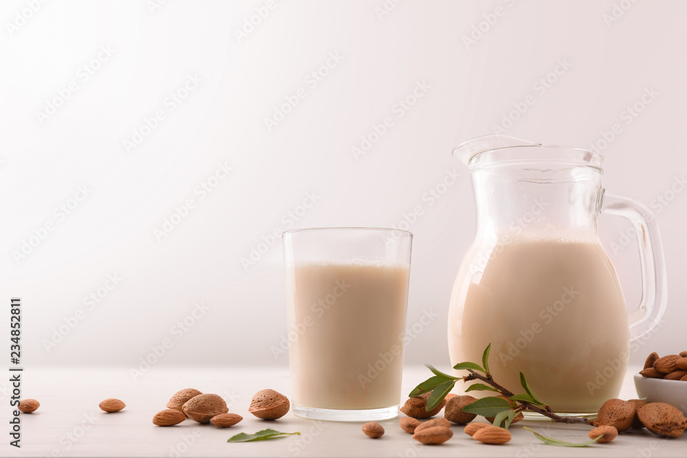 Healthy nutrition with almond drink in glass and glass jar Healthy nutrition with almond drink in glass and glass jar