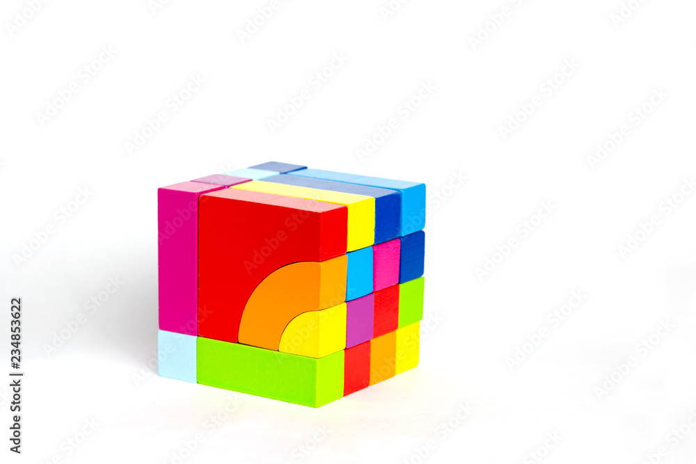 Obraz premium Colored wooden blocks, cubes, build on a light white background.A cube of colored wooden details