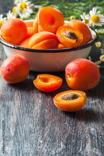 Fresh organic apricots on rustic wooden background.
