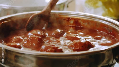 Cooking meatballs in tomato sauce photo