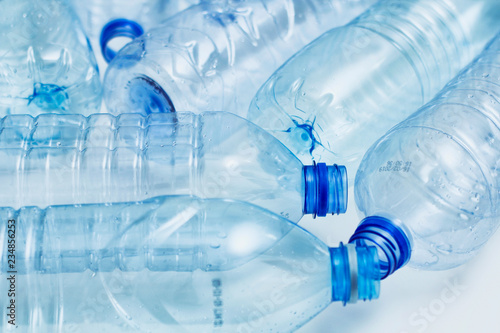 Blue used plastic bottles. Recycle concept. Clear bottles on white background. Making process. 