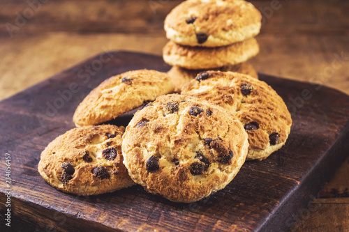 Chocolate chip cookies heap on wooden board