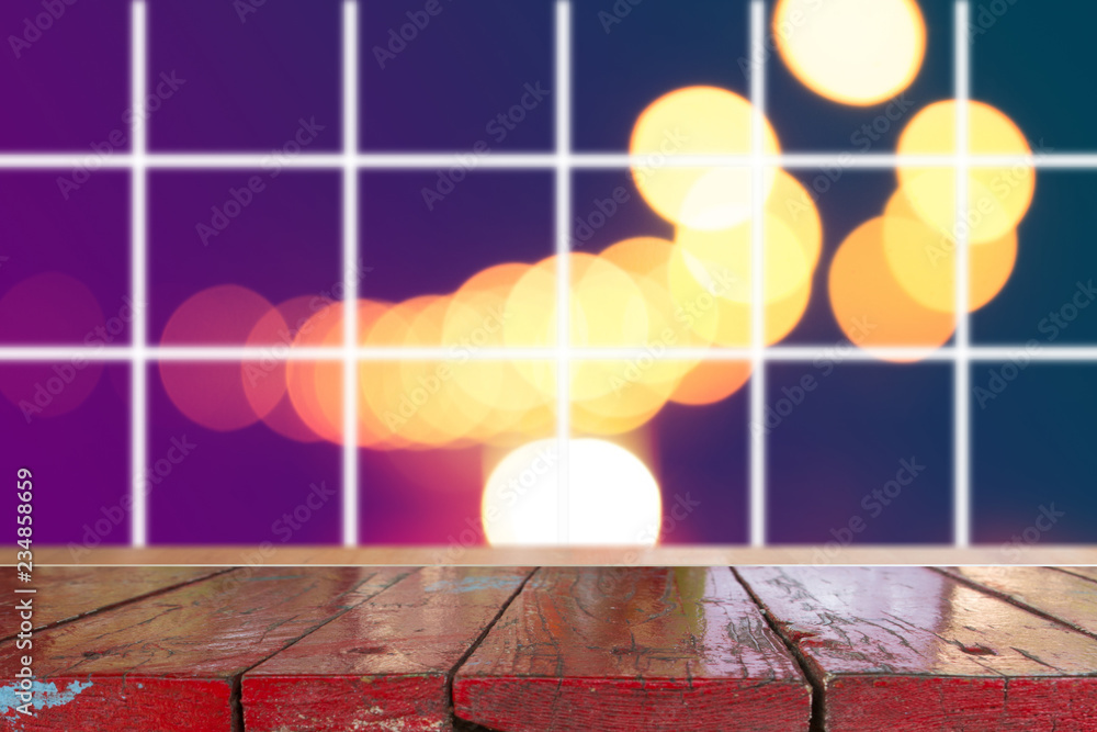 Wooden desk with Blurred light on road in city with bokeh abstract background